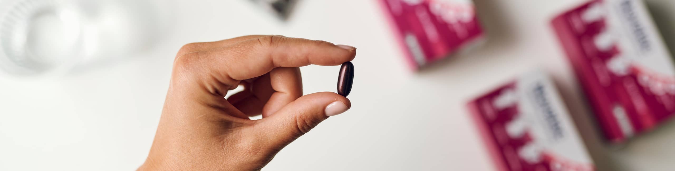 Roka, ki drži kapsulo Novalac z aktivno folno kislino Quatrefolic.